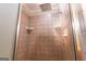 Tiled shower featuring a rainfall shower head and convenient soap and shampoo shelves at 411 Hampton Rd, Fayetteville, GA 30215