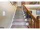 Carpeted staircase with decorative wrought iron and wood railing, leading to the upper level at 411 Hampton Rd, Fayetteville, GA 30215
