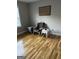 Neutral bedroom featuring hardwood flooring, a chair, and small accent tables at 2074 Ayers Creek Ct, Villa Rica, GA 30180