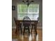 Bright dining area with hardwood floors, a wooden table, and views of the backyard at 2074 Ayers Creek Ct, Villa Rica, GA 30180