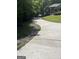 Long concrete driveway leading up to the house, surrounded by lush greenery at 2074 Ayers Creek Ct, Villa Rica, GA 30180