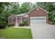 Charming brick home with a manicured lawn, attached garage, and beautifully landscaped front yard at 2074 Ayers Creek Ct, Villa Rica, GA 30180