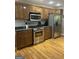 Modern kitchen with stainless steel appliances, granite countertops, and wooden cabinetry at 2074 Ayers Creek Ct, Villa Rica, GA 30180