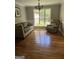 Cozy living room with hardwood floors, a comfortable couch, and a bright window at 2074 Ayers Creek Ct, Villa Rica, GA 30180