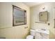 A full bathroom with a sink, toilet, mirror, and towel rack at 6109 Oakwood Sw Cir, Covington, GA 30014
