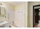 Bathroom featuring tub with wall-mounted shower and vanity sink at 6109 Oakwood Sw Cir, Covington, GA 30014