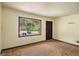 Simple bedroom with panelled walls and a view of the outdoors at 6109 Oakwood Sw Cir, Covington, GA 30014