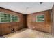 Bedroom with paneled walls and windows with the view of the outdoors at 6109 Oakwood Sw Cir, Covington, GA 30014