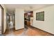 Hallway leads to a kitchen with wood cabinets and a window view at 6109 Oakwood Sw Cir, Covington, GA 30014