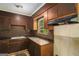 A functional kitchen with wood cabinets and an exhaust fan at 6109 Oakwood Sw Cir, Covington, GA 30014