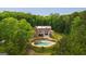 Aerial shot of a brick home with a pool surrounded by lush trees, offering privacy and tranquility at 1212 Lee Whatley Dr, Lithonia, GA 30058