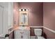 Charming bathroom with decorative mirror, vanity, and a classic toilet design at 1212 Lee Whatley Dr, Lithonia, GA 30058