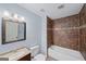 Bathroom with tiled shower-tub combo and a modern vanity, offering a clean and functional space at 1212 Lee Whatley Dr, Lithonia, GA 30058