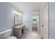 Modern bathroom features a vanity with a stone countertop, tiled floors and a toilet at 1212 Lee Whatley Dr, Lithonia, GA 30058