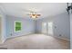 Bright bedroom with carpet, a ceiling fan, neutral paint, and French doors to the outside at 1212 Lee Whatley Dr, Lithonia, GA 30058