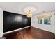 Bedroom with wood floors, a large window, and modern light fixture, a cozy retreat in a home at 1212 Lee Whatley Dr, Lithonia, GA 30058