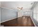 Large main bedroom featuring hardwood floors, a ceiling fan, and plenty of natural light at 1212 Lee Whatley Dr, Lithonia, GA 30058