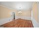 Open dining room featuring hardwood floors, modern chandelier, and bright, neutral walls at 1212 Lee Whatley Dr, Lithonia, GA 30058