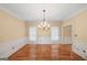 Dining room with hardwood floors, decorative chandelier, and neutral walls, ready for entertaining at 1212 Lee Whatley Dr, Lithonia, GA 30058