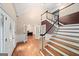 Grand foyer with hardwood floors, staircase, and glass paned sidelights at entrance at 1212 Lee Whatley Dr, Lithonia, GA 30058