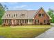 Charming brick home featuring well-manicured lawn, dormer windows, and classic shutters at 1212 Lee Whatley Dr, Lithonia, GA 30058