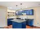 Modern kitchen features blue cabinets, granite counters, and a central island, perfect for cooking and entertaining at 1212 Lee Whatley Dr, Lithonia, GA 30058
