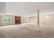 Spacious carpeted living room featuring a brick fireplace and ample natural light from multiple windows at 1212 Lee Whatley Dr, Lithonia, GA 30058
