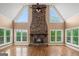 Grand living room with a stone fireplace and beautiful natural light at 1212 Lee Whatley Dr, Lithonia, GA 30058