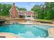 Stunning pool area with stone waterfall, spa, and luxurious backyard in a beautiful brick home setting at 1212 Lee Whatley Dr, Lithonia, GA 30058
