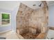 This walk-in shower features gorgeous travertine tile at 1212 Lee Whatley Dr, Lithonia, GA 30058