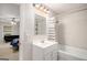 This bright bathroom has a white sink, tub/shower combo and a doorway leading to the bedroom at 1125 Babbs Mill Rd, Hampton, GA 30228