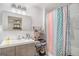 Bathroom featuring a white vanity, large mirror and decorative shower curtain at 1125 Babbs Mill Rd, Hampton, GA 30228