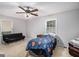 Carpeted bedroom with ceiling fan, a single window and a futon that can be used as a sofa or bed at 1125 Babbs Mill Rd, Hampton, GA 30228