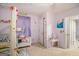 This charming bedroom features lavender walls, a white canopy bed and an adorable little vanity at 1125 Babbs Mill Rd, Hampton, GA 30228
