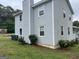 View of a two story home with light blue siding, a chimney, and green landscaping at 1125 Babbs Mill Rd, Hampton, GA 30228