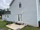 Home with light blue siding and a backyard patio with outdoor lights above the door at 1125 Babbs Mill Rd, Hampton, GA 30228