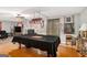 Spacious game room with hardwood floors, a fireplace, a ceiling fan, and a pool table at 1125 Babbs Mill Rd, Hampton, GA 30228
