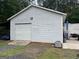Exterior shot of a garage with siding and a grey door at 1125 Babbs Mill Rd, Hampton, GA 30228