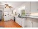 A bright kitchen featuring white cabinetry, stainless steel appliances, and hardwood floors at 1125 Babbs Mill Rd, Hampton, GA 30228