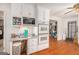 A bright kitchen featuring white cabinetry and built-in microwave and ovens, and hardwood floors at 1125 Babbs Mill Rd, Hampton, GA 30228