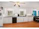 A bright kitchen featuring white cabinetry, stainless steel appliances, and hardwood floors at 1125 Babbs Mill Rd, Hampton, GA 30228