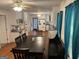 Eat-in kitchen features white cabinets and appliances, and a large dining table at 1125 Babbs Mill Rd, Hampton, GA 30228