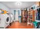 A fully equipped laundry room with a washer, dryer, storage, and hardwood floors at 1125 Babbs Mill Rd, Hampton, GA 30228