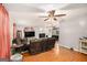 Large living room featuring hardwood floors, sofas, a fireplace, and multiple ceiling fans at 1125 Babbs Mill Rd, Hampton, GA 30228