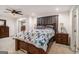 This main bedroom features neutral carpet, a ceiling fan and two side tables with lamps for relaxing at night at 1125 Babbs Mill Rd, Hampton, GA 30228