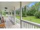 Relaxing porch with wood floors and white railings, overlooking the well-maintained yard at 1125 Babbs Mill Rd, Hampton, GA 30228