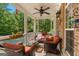 Inviting screened porch with comfortable seating, ceiling fan, and view of the lush backyard at 2294 Hollonville Rd, Brooks, GA 30205