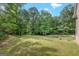 Spacious backyard, enhanced by trees, offering serene outdoor space and privacy at 2294 Hollonville Rd, Brooks, GA 30205