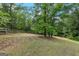 Serene backyard featuring mature trees and well maintained fence line at 2294 Hollonville Rd, Brooks, GA 30205