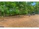Large flat backyard and chicken coop nestled amongst the trees of this private estate at 2294 Hollonville Rd, Brooks, GA 30205